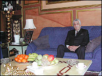 Photo of Kassar sitting on couch