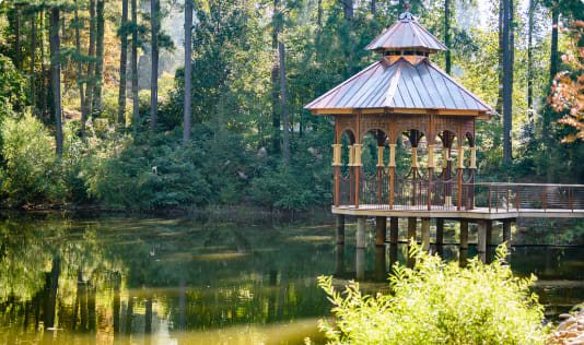 A gazebo sits out over a pond in the South Carolina Botanical Garden.